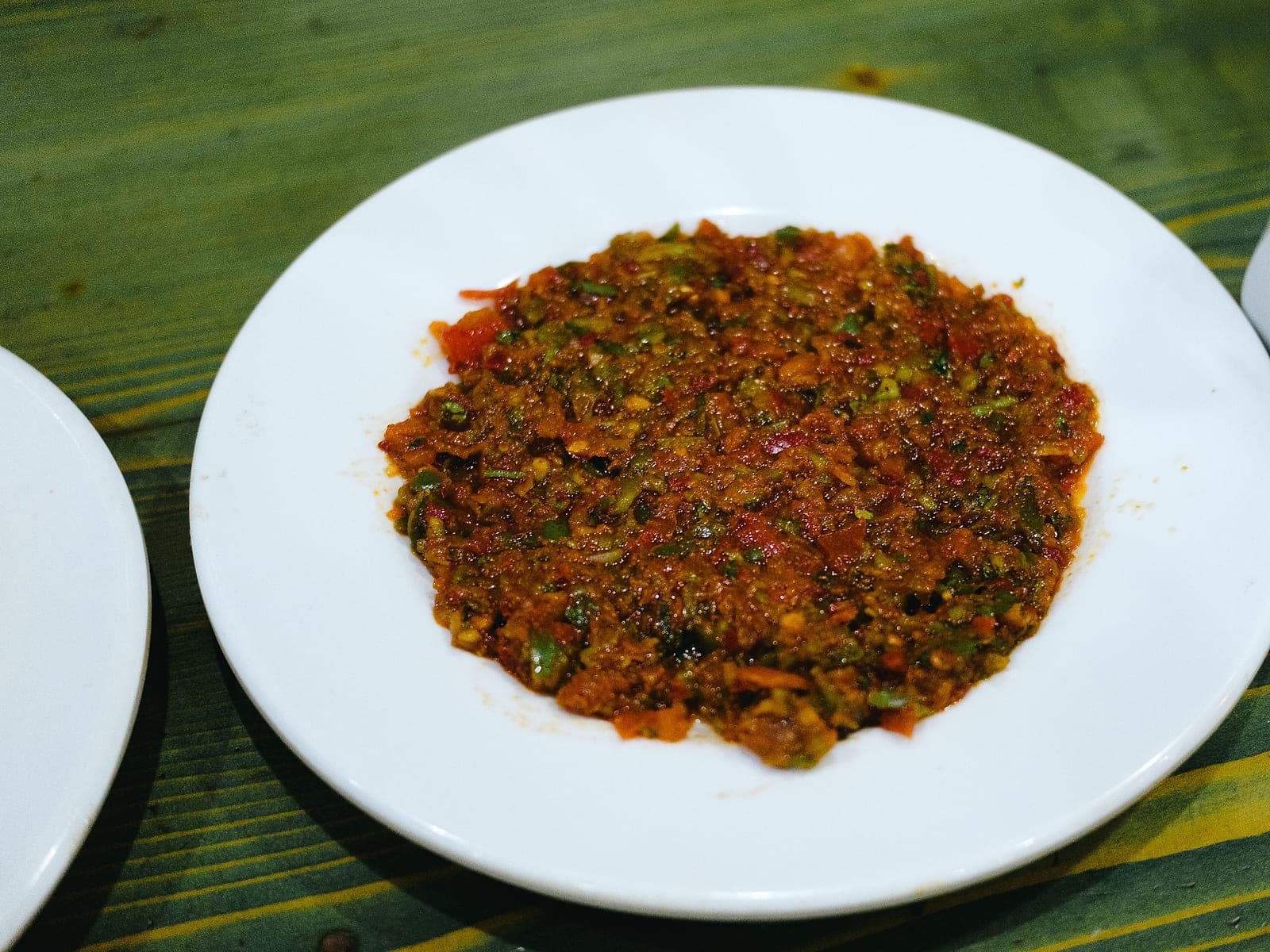 Moroccan chermoula — a green herb and spice marinade in a bowl with coriander, garlic, lemon and paprika