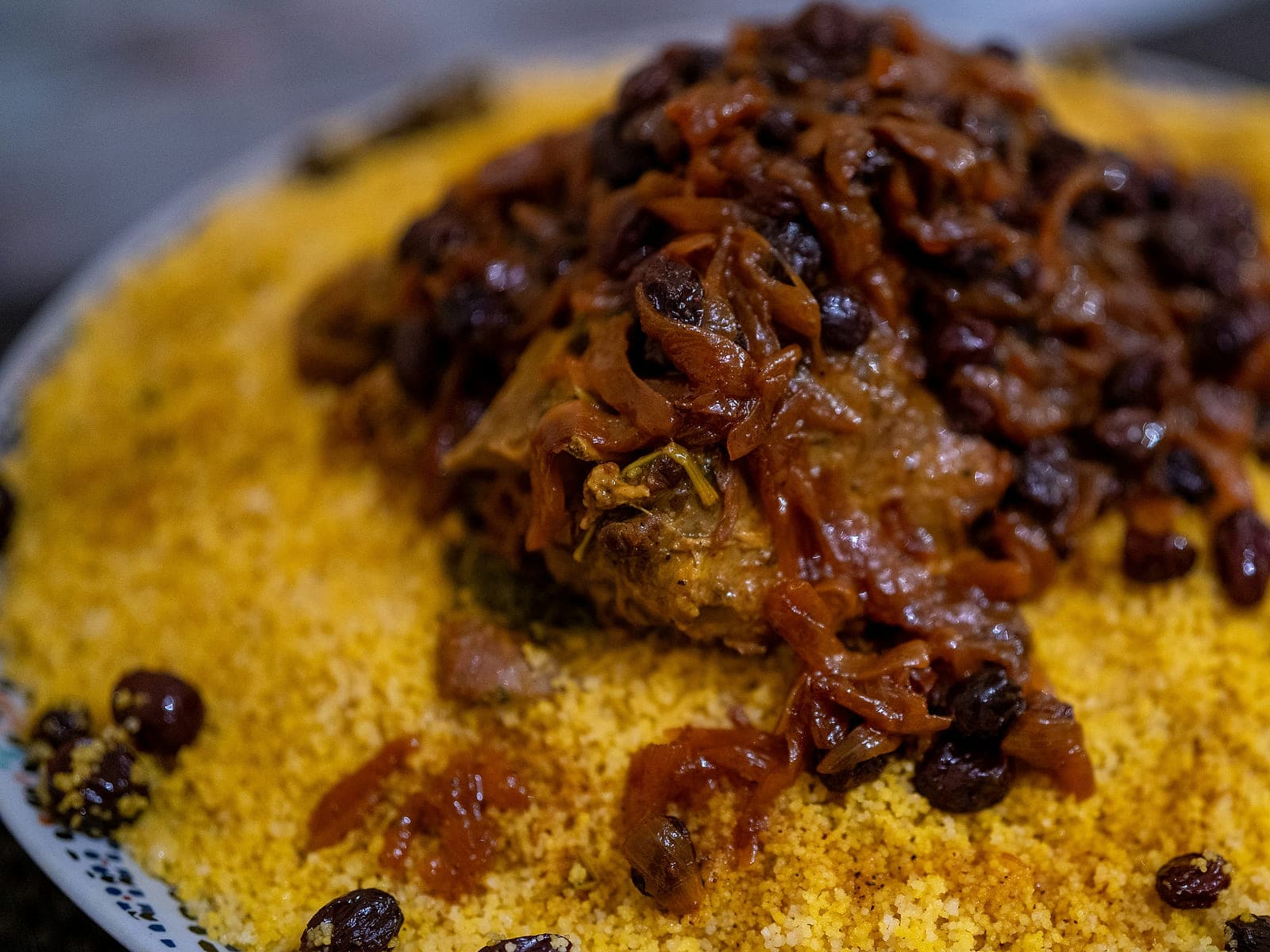 Moroccan couscous tfaya — a mound of couscous topped with caramelised onions, raisins, almonds and chicken