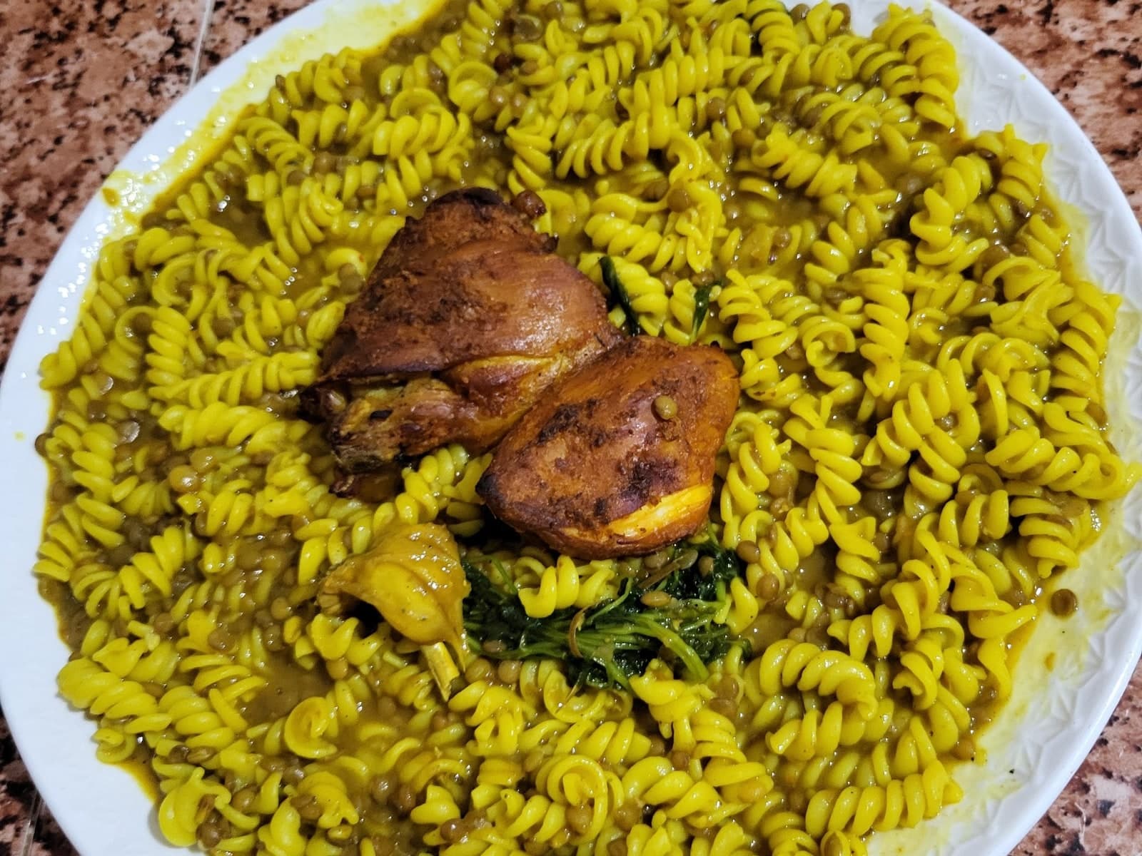 Moroccan rfissa with pasta — fusilli and green lentils in a fenugreek broth, with oven-browned chicken and coriander on a white plate